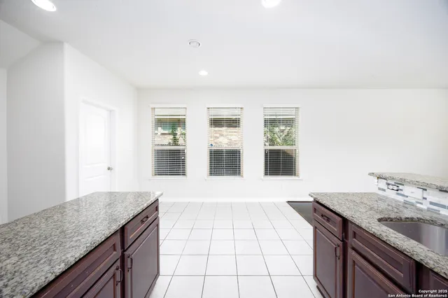 a view of a kitchen with granite countertop a sink and a granite counter tops