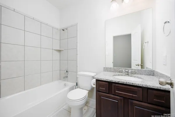 a bathroom with a sink a toilet and bathtub