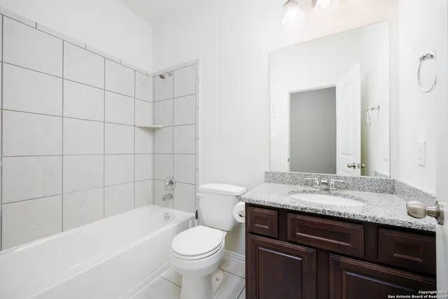 a bathroom with a sink a toilet and bathtub