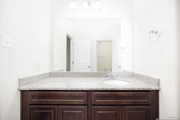 a view of bathroom with granite countertop