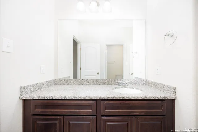 a view of bathroom with granite countertop