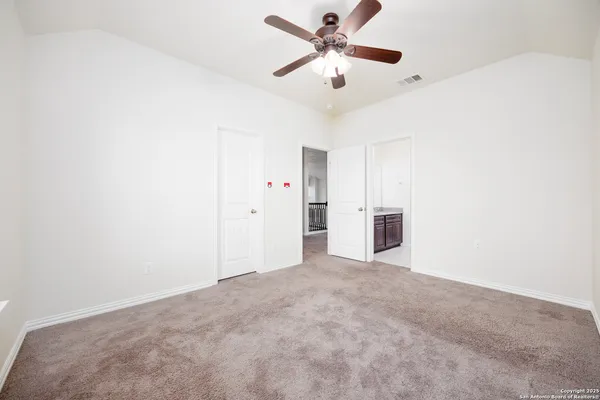 an empty room with a ceiling fan and a window