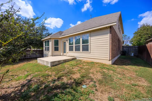 a view of a house with backyard and sitting area