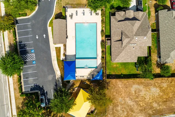 an aerial view of a house with a swimming pool