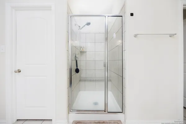 a bathroom with a glass shower door
