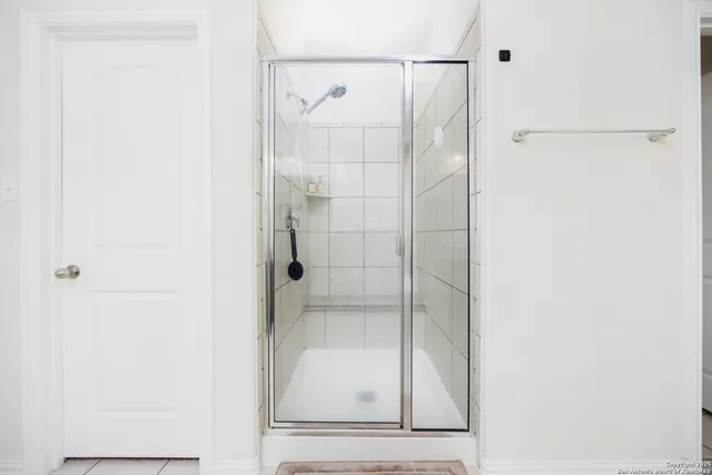 a bathroom with a glass shower door