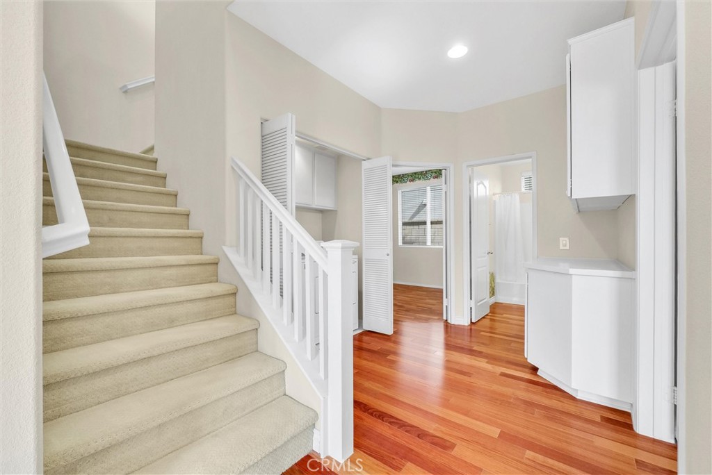 698 Legacy Drive Brea, CA 92821 - Photo 18 of 48 a view of an entryway with wooden floor and a kitchen view