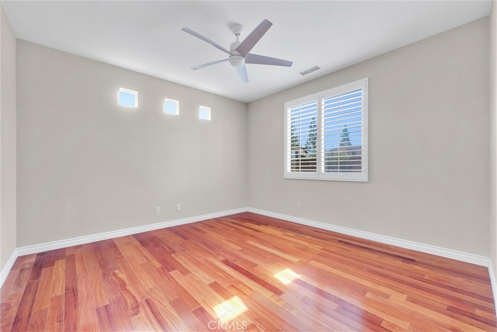 698 Legacy Drive Brea, CA 92821 - Photo 20 of 48 a view of empty room with wooden floor and fan