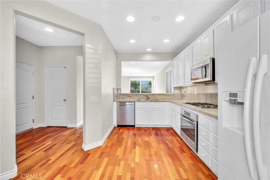 698 Legacy Drive Brea, CA 92821 - Photo 8 of 48 a kitchen with stainless steel appliances granite countertop a refrigerator and a stove top oven
