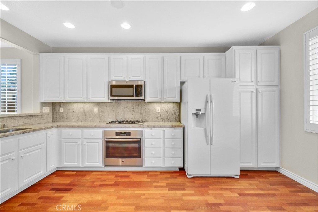 698 Legacy Drive Brea, CA 92821 - Photo 9 of 48 a kitchen with stainless steel appliances granite countertop a stove a sink and a microwave