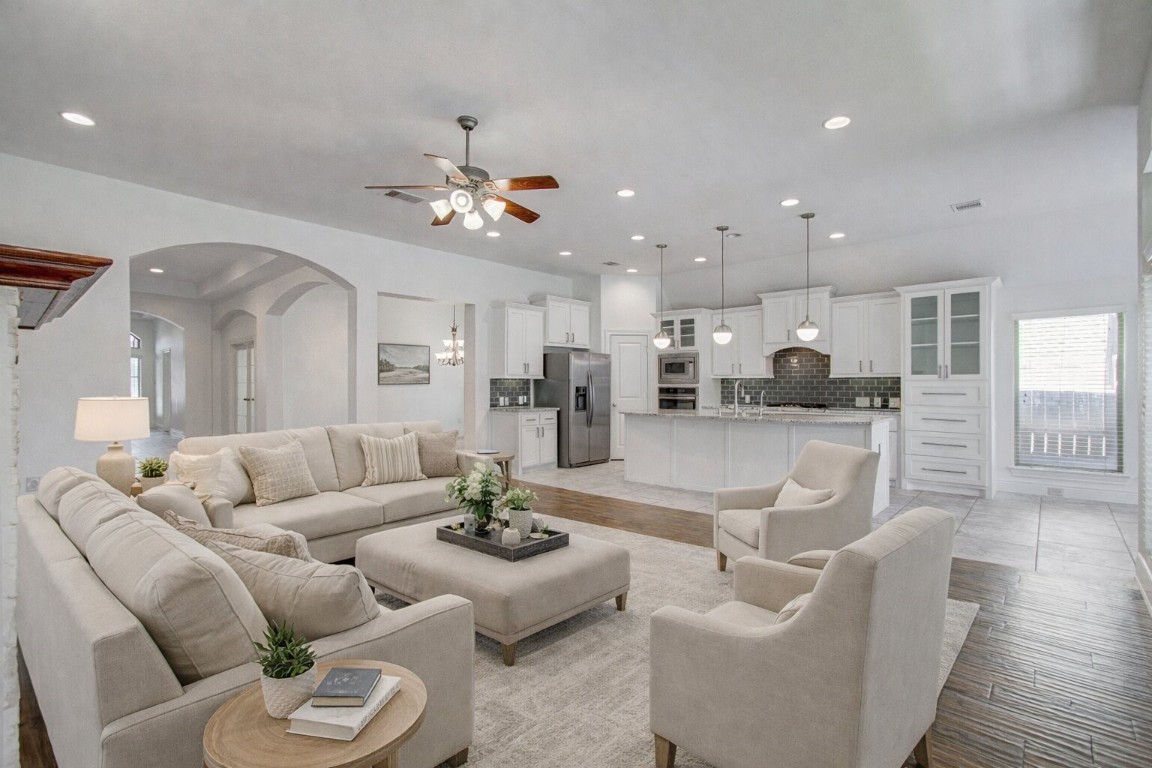 6614 Rising Hills Lane Sugar Land, TX 77479 - Photo 11 of 28 a living room with furniture kitchen and a chandelier