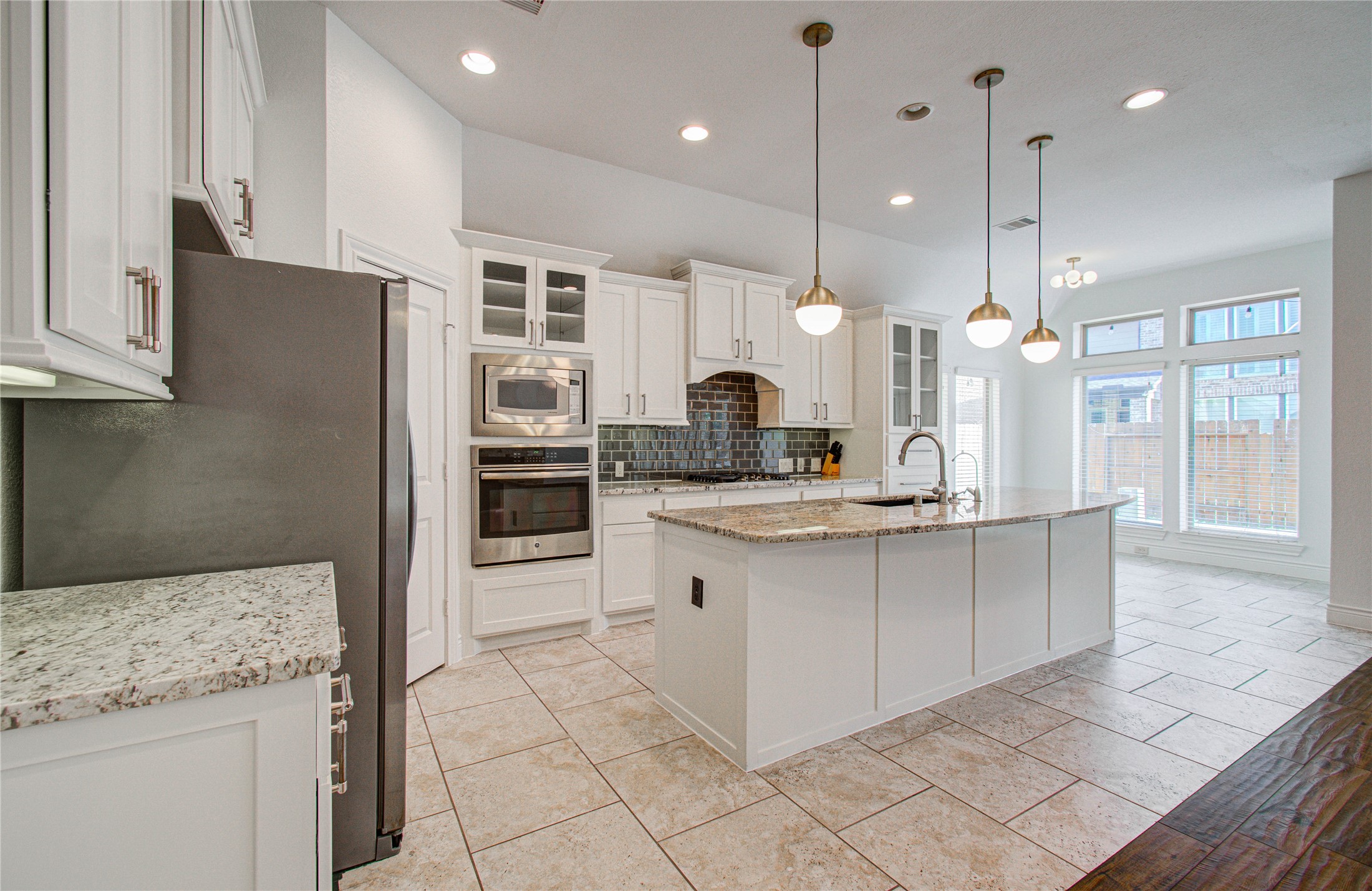 6614 Rising Hills Lane Sugar Land, TX 77479 - Photo 12 of 28 a kitchen with stainless steel appliances granite countertop a sink a stove and a refrigerator