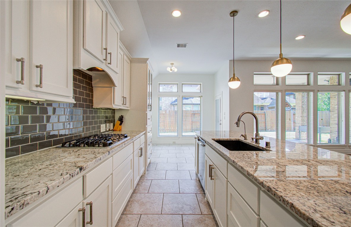 6614 Rising Hills Lane Sugar Land, TX 77479 - Photo 17 of 28 a kitchen with granite countertop a sink a counter top space appliances and cabinets