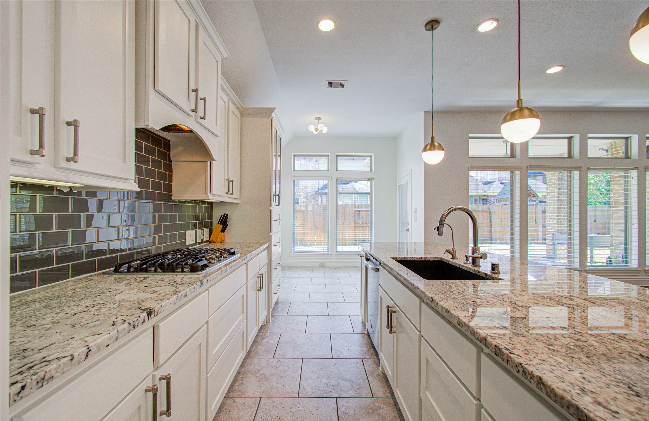 6614 Rising Hills Lane Sugar Land, TX 77479 - Photo 17 of 28 a kitchen with granite countertop a sink a counter top space appliances and cabinets