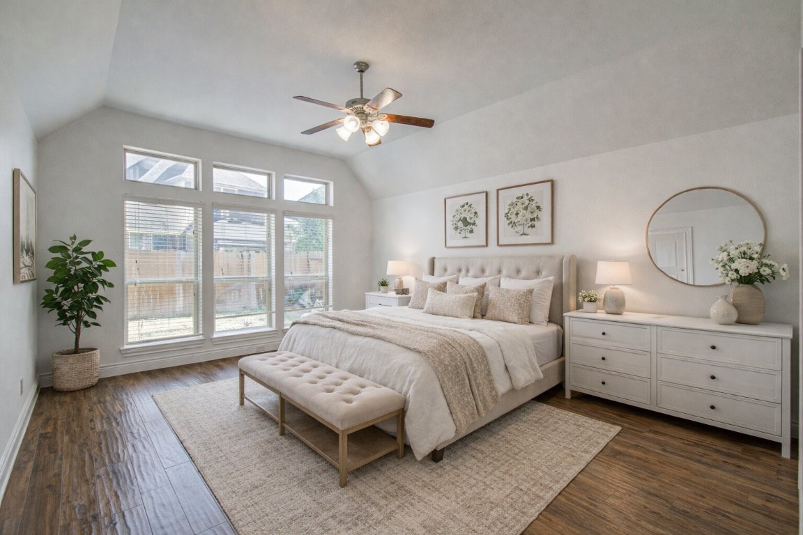6614 Rising Hills Lane Sugar Land, TX 77479 - Photo 22 of 28 a spacious bedroom with a large bed and a chandelier