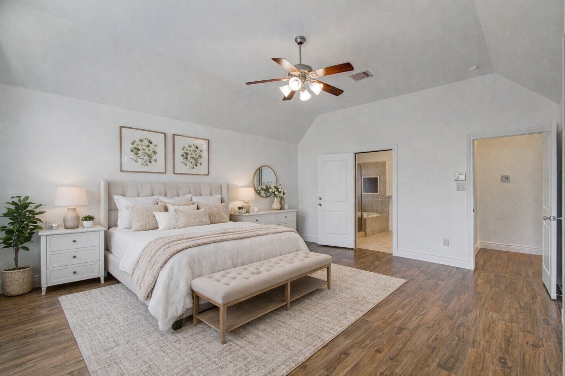6614 Rising Hills Lane Sugar Land, TX 77479 - Photo 23 of 28 a bedroom with a large bed and a chandelier