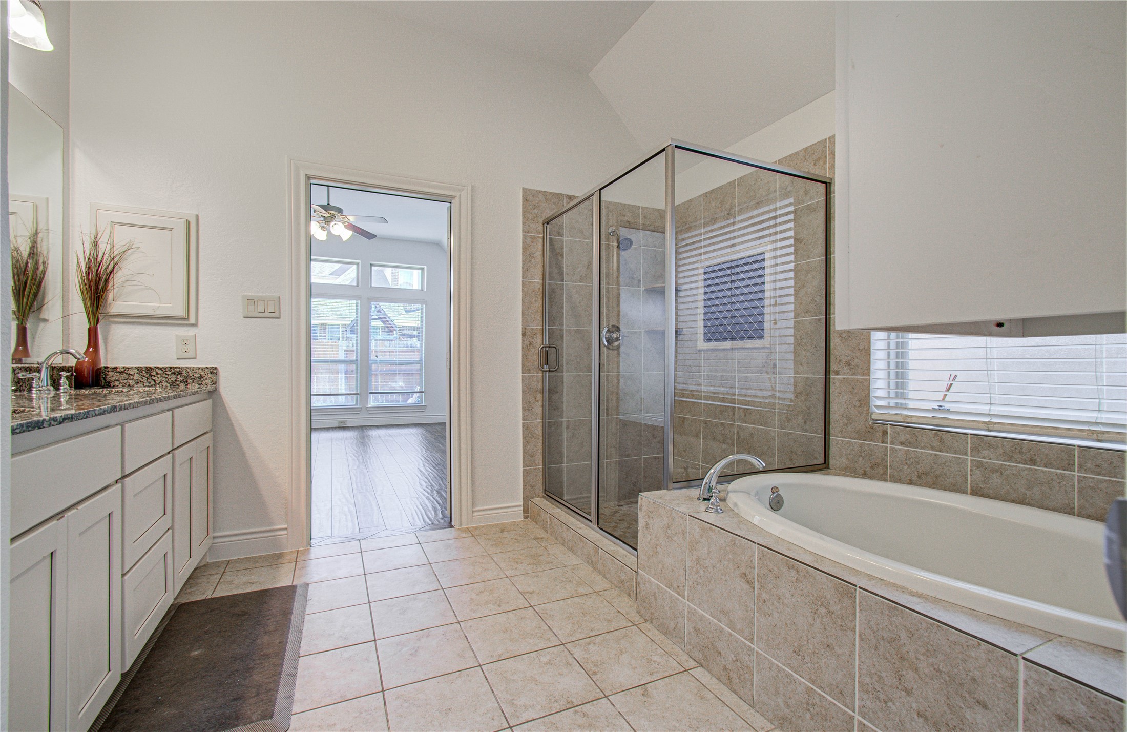 6614 Rising Hills Lane Sugar Land, TX 77479 - Photo 25 of 28 a bathroom with a granite countertop sink a mirror and a bathtub