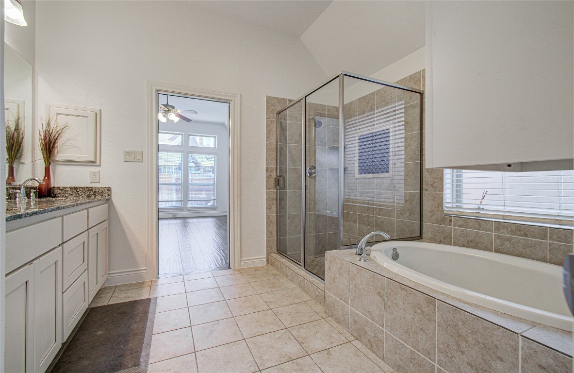 6614 Rising Hills Lane Sugar Land, TX 77479 - Photo 25 of 28 a bathroom with a granite countertop sink a mirror and a bathtub