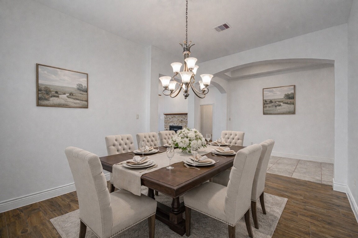 6614 Rising Hills Lane Sugar Land, TX 77479 - Photo 9 of 28 a view of a dining room with furniture wooden floor and a chandelier