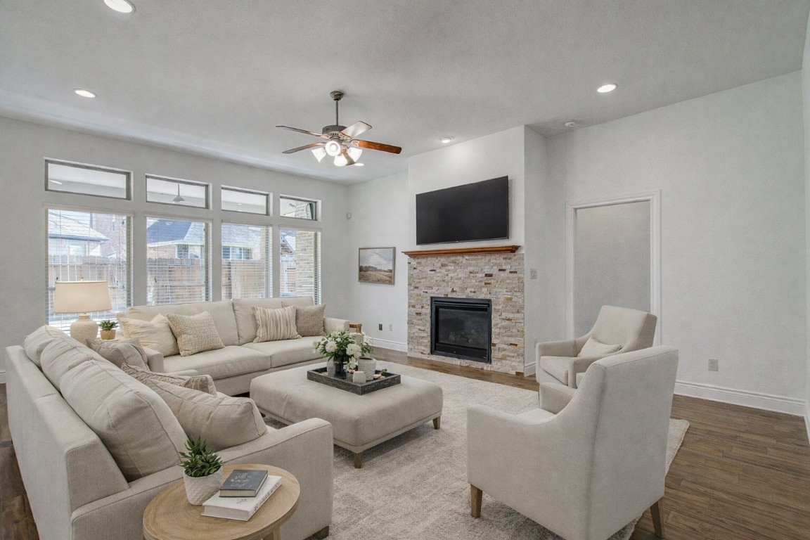 6614 Rising Hills Lane Sugar Land, TX 77479 - Photo 10 of 28 a living room with furniture a fireplace and a flat screen tv