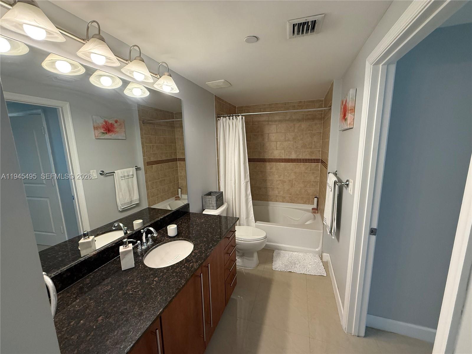7350 Southwest 89th Street, Unit 1908S Miami, FL 33156 - Photo 16 of 28 a bathroom with a sink vanity granite and a mirror