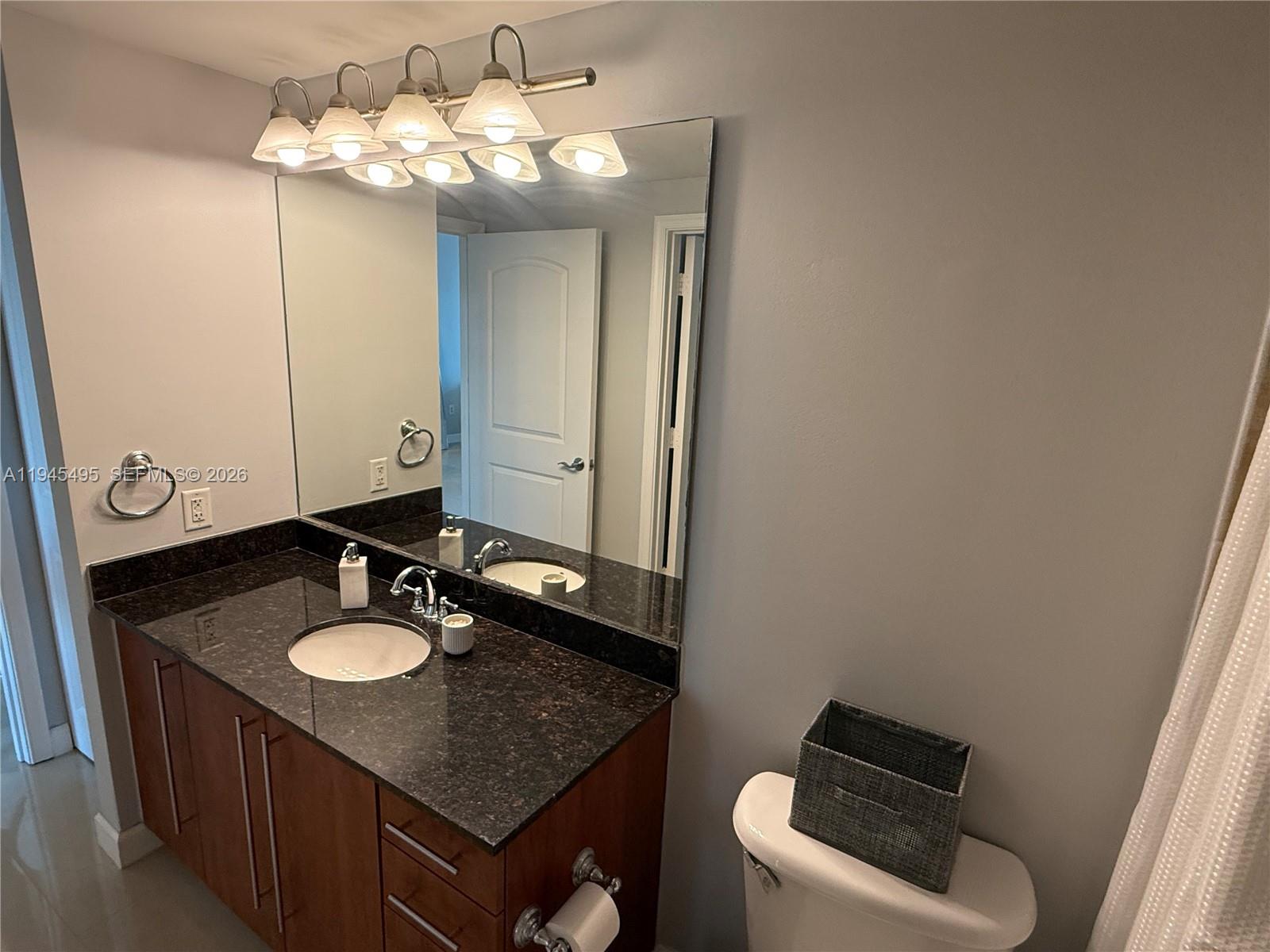 7350 Southwest 89th Street, Unit 1908S Miami, FL 33156 - Photo 17 of 28 a bathroom with a sink and a mirror