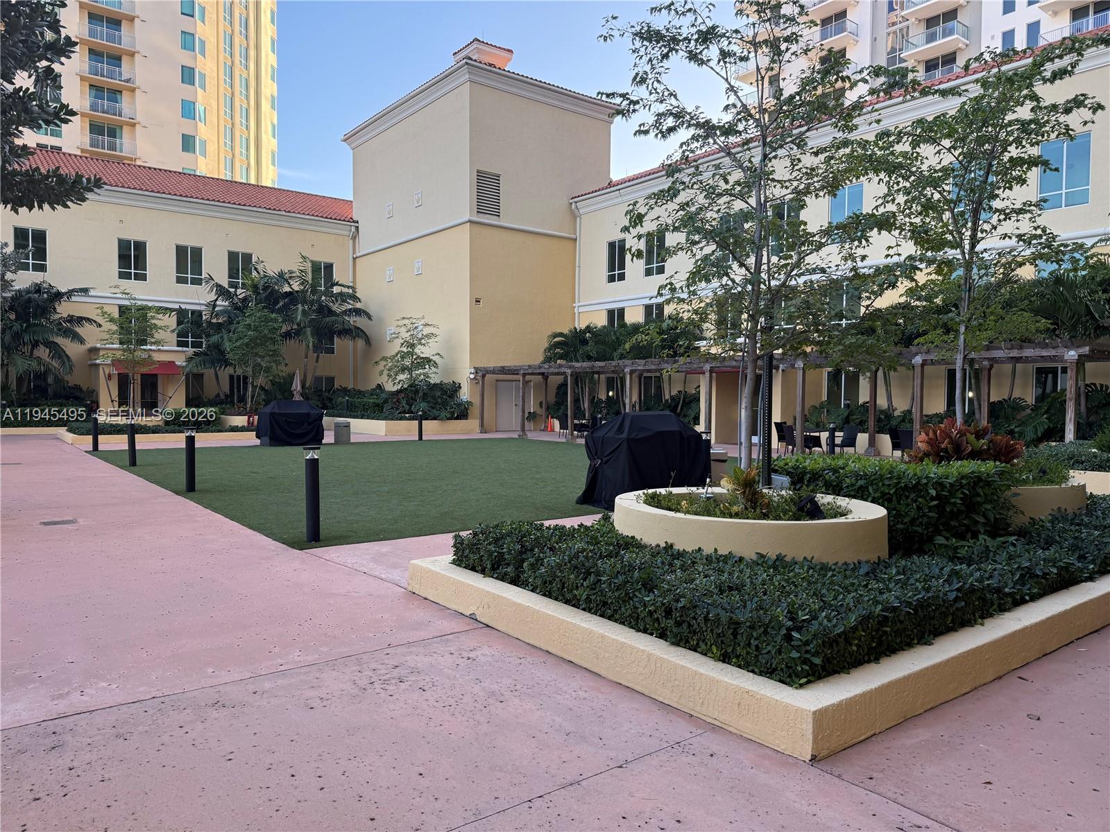 7350 Southwest 89th Street, Unit 1908S Miami, FL 33156 - Photo 27 of 28 a front view of a house with garden and trees