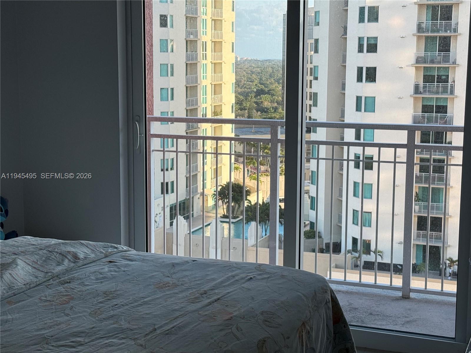 7350 Southwest 89th Street, Unit 1908S Miami, FL 33156 - Photo 8 of 28 a bedroom with a bed and a large window