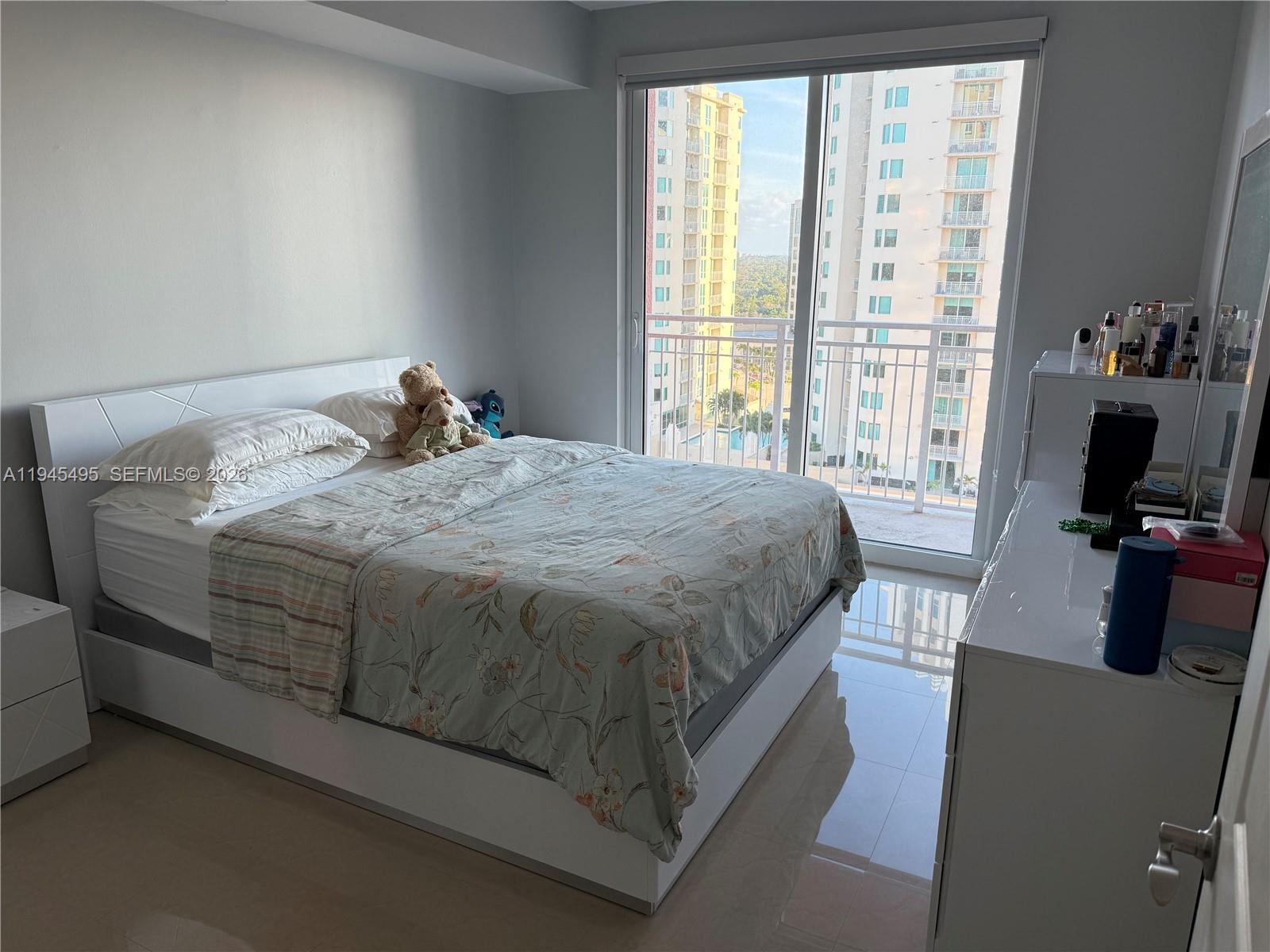 7350 Southwest 89th Street, Unit 1908S Miami, FL 33156 - Photo 9 of 28 a bedroom with a bed and a flat screen tv