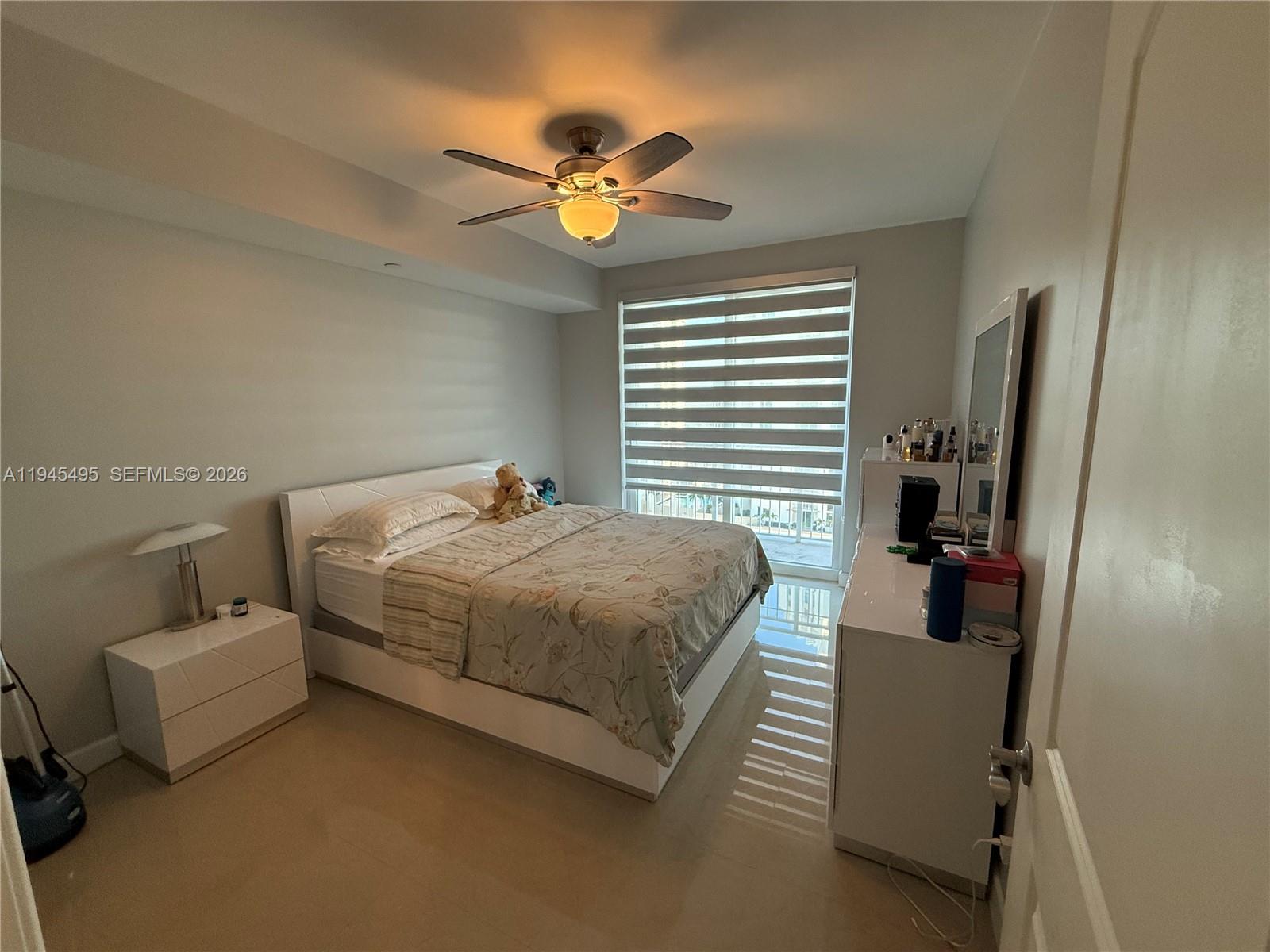 7350 Southwest 89th Street, Unit 1908S Miami, FL 33156 - Photo 10 of 28 a bedroom with a bed and a chandelier