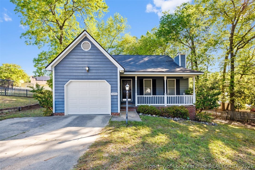 1205 Crossbend Court Fayetteville, NC 28314 - Photo 2 of 37 a front view of a house with a yard and garage