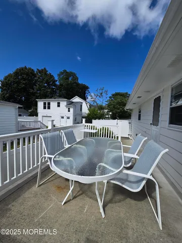 a backyard of a house with table and chairs