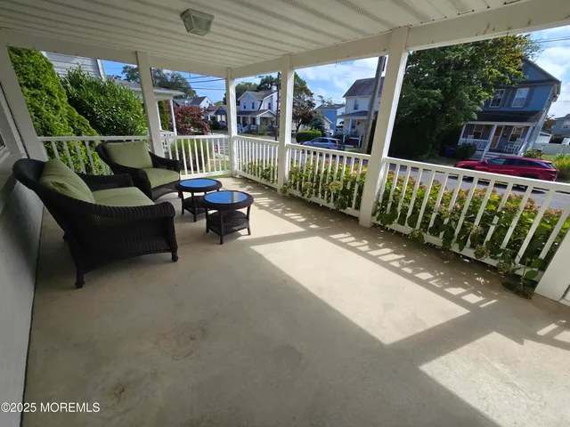 a view of a patio with a table and chairs