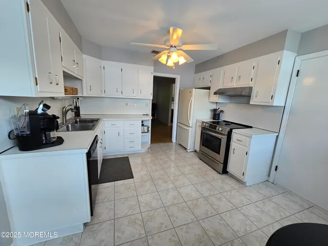 a kitchen with a sink a stove and refrigerator