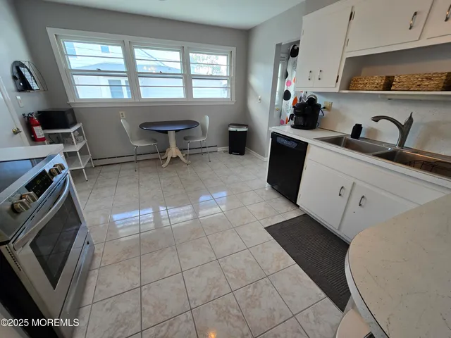 a kitchen with a sink appliances and cabinets