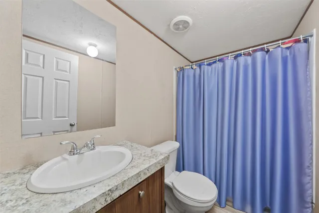 a view of a patio with table and chairs and potted plants
