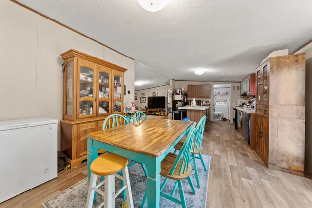 a dining room with furniture and wooden floor