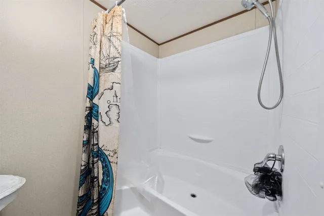 a bathroom with a bathtub and shower