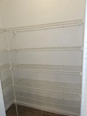 a kitchen with granite countertop a sink and white cabinets