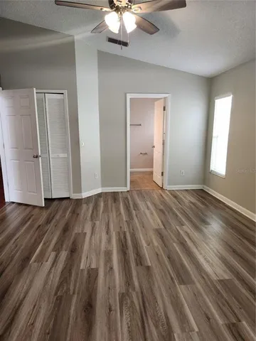 a bathroom with a sink vanity and shower