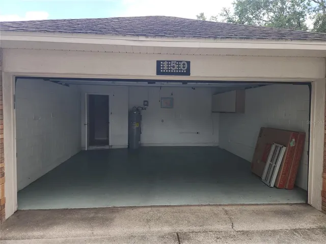 a view of empty room with wooden floor and iron stairs