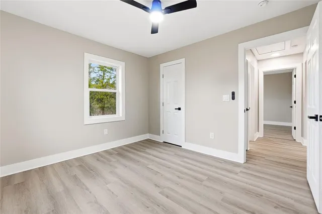 an empty room with wooden floor and a window
