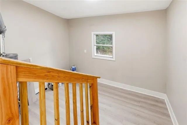 a large bed sitting in a bedroom next to a window