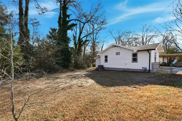 a large tree in front of a house