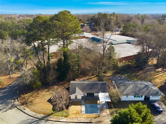 an aerial view of a house with a yard swimming pool and outdoor seating