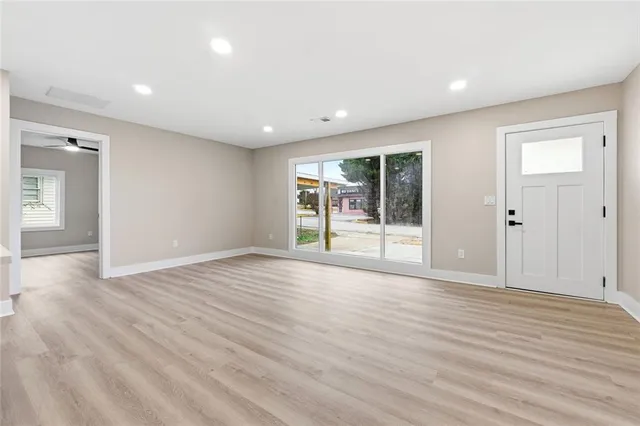 wooden floor in an empty room with a window