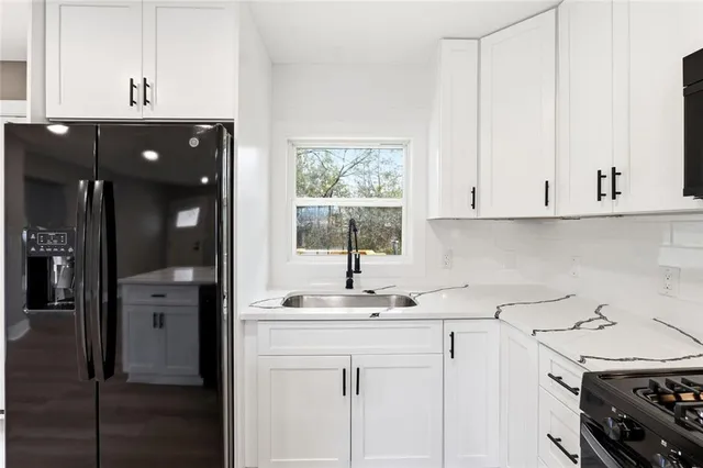 a kitchen with a sink cabinets and appliances