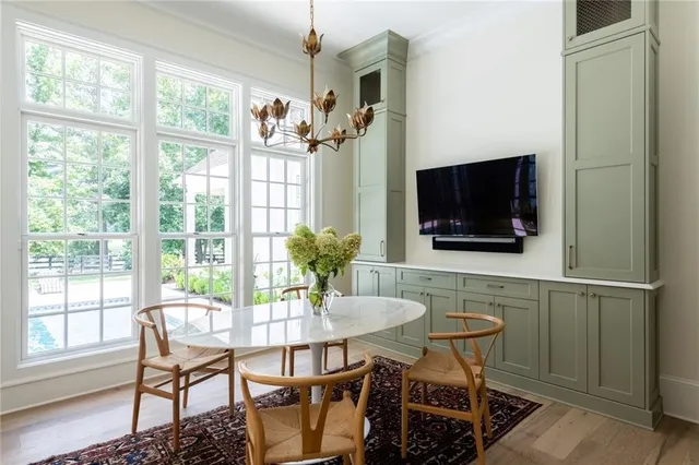 a dining room with furniture a flat screen tv and a chandelier