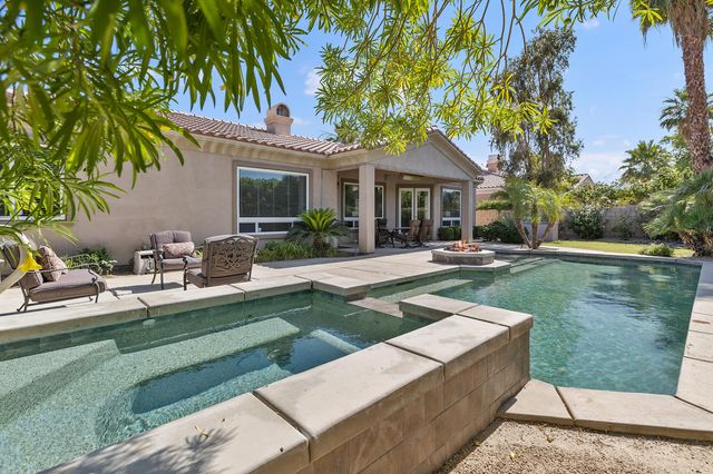 a view of a house with a yard patio and swimming pool