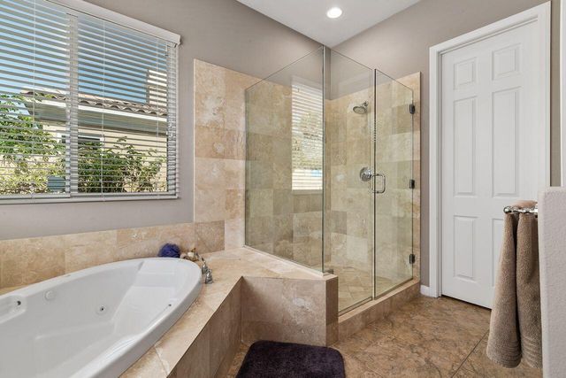 a bathroom with a tub shower and sink